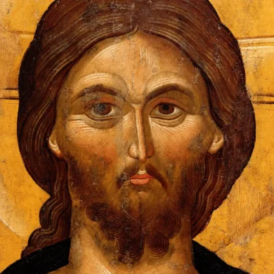 Detalle Del Rostro De Cristo Con La Cabellera Ondulada Cayendo Sobre El Hombro Derecho, Los Pómulos Prominentes Y La Expresión Seria.