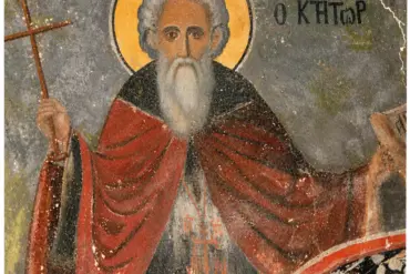 Ο Όσιος Ιωάννης ο Ίβηρας με λευκή γενειάδα, σταυρό και ειλητάριο σε τοιχογραφία της Μονής Ιβήρων.